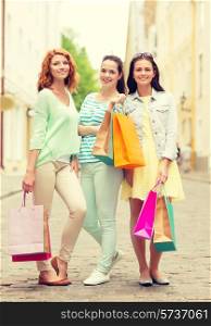 tourism, travel, vacation, shopping and friendship concept - smiling teenage girls with shopping bags on street