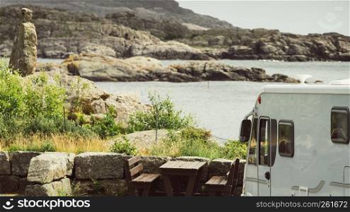 Tourism vacation and travel. Camper van and rocky coast landscape of southern Norway with an ocean view in Rogaland county Norway.. Camper car on coast of Norway with ocean view