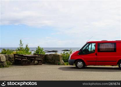 Tourism vacation and travel. Camper van and rocky coast landscape of southern Norway with an ocean view in Rogaland county Norway.. Camper car on coast of Norway with ocean view