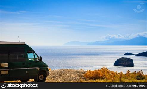 Tourism vacation and travel. Camper van motorhome on beach sea shore in summer time, Greece. Camper car on beach sea shore. Travel