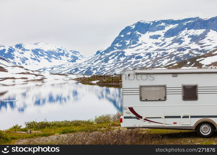 Tourism vacation and travel. Camper van motorhome on camping site rest place in norwegian mountains. Camper car in norwegian mountains