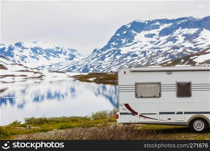 Tourism vacation and travel. Camper van motorhome on camping site rest place in norwegian mountains. Camper car in norwegian mountains