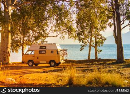 Tourism vacation and travel. Camper van on beach seashore in Greece. Camper car on beach seashore