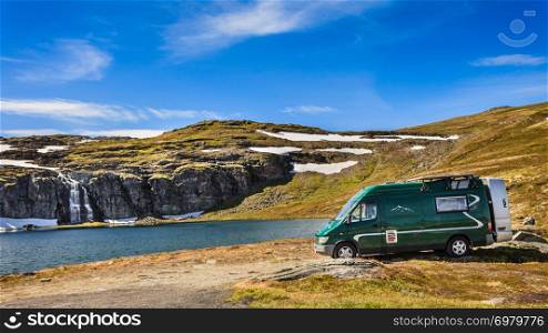 Tourism vacation and travel. Camper van on camp site at mountain lake Flotvatnet. National tourist route Aurlandsfjellet.. Camper car at mountain lake Aurlandsfjellet Norway