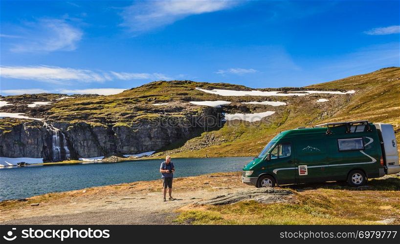 Tourism vacation and travel. Camper van on camp site at mountain lake Flotvatnet. National tourist route Aurlandsfjellet.. Camper car at mountain lake Flotvatnet, Aurlandsfjellet Norway
