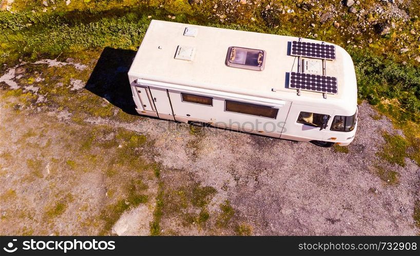 Tourism vacation and travel. Camper van with solar panels on roof in summer mountains landscape. National tourist route Aurlandsfjellet.. Camper car in norwegian mountains