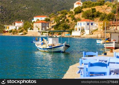 Tourism vacation and travel. Fishing boat on blue sea surface in greek resort marina.. Fishing boat in greek marina