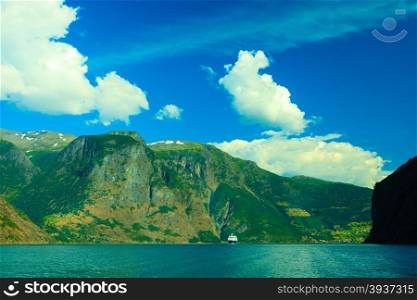 Tourism vacation and travel. Mountains and cruise ship on fjord Sognefjord in Norway, Scandinavia.