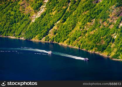 Tourism vacation and travel. Mountains landscape and cruising ship on fjord in Norway Scandinavia.. Cruise ship on norwegian fjord