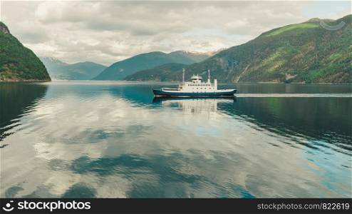 Tourism vacation and travel. Mountains landscape and ferryboat sailing on fjord in Norway Scandinavia Europe. Norddalsfjorden as seen from ferry. Beautiful nature. Ferry boat ship on fjord in Norway
