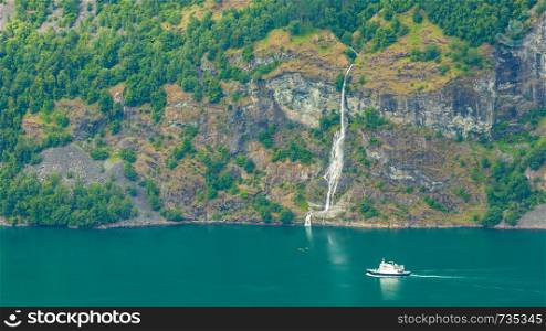 Tourism vacation and travel. Mountains landscape and large cruising ships on fjord in Norway Scandinavia.. Cruise ship on norwegian fjord