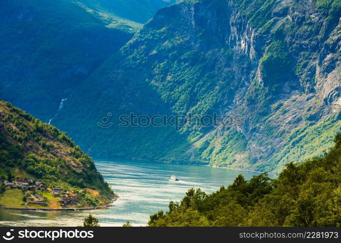 Tourism vacation and travel. Mountains landscape and ship ferry boat on Geirangerfjord fjord in Norway Scandinavia.. Cruise ship on Geirangerfjord in Norway