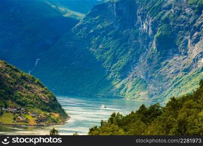 Tourism vacation and travel. Mountains landscape and ship ferry boat on Geirangerfjord fjord in Norway Scandinavia.. Cruise ship on Geirangerfjord in Norway