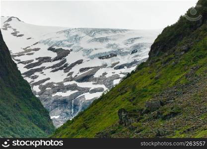 Tourism vacation and travel. Mountains landscape at summer with ice glacier, Stryn municipality in the county of Sogn og Fjordanein Norway, Scandinavia.. Mountains summer landscape in Norway.