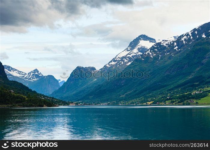 Tourism vacation and travel. Mountains landscape dark stormy clouds and fjord in Norway Scandinavia Europe. Beautiful nature. Mountains landscape and fjord in Norway