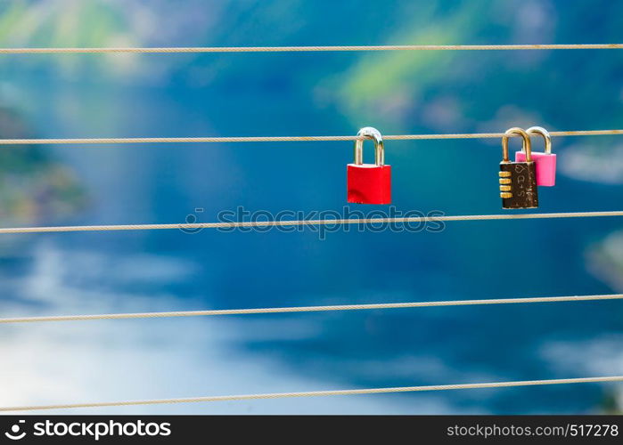 Tourism vacation and travel. Red love lock padlock on bridge and mountains, view over magical Geirangerfjorden from Flydalsjuvet viewpoint, Norway Scandinavia.. Red padlock and Geirangerfjord from Flydasjuvet viewpoint Norway