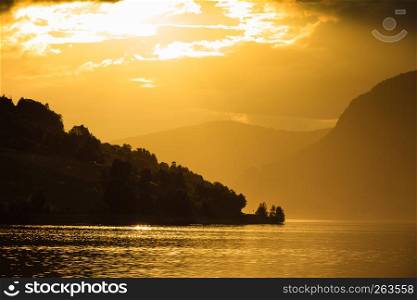 Tourism vacation and travel. Red sunset over fjords mountains landscape, Sogn og Fjordane county, Norway Scandinavia Europe. Beautiful nature. Red sunset over sea fjord Norway