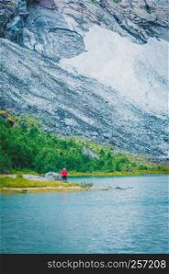Tourism vacation and travel. Tourist woman enjoying mountains landscape at summer in Norway, Scandinavia.. Tourist woman enjoying mountains landscape in Norway.