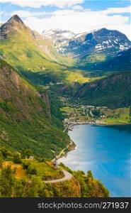 Tourism vacation and traveling. Fantastic view on Geirangerfjord green mountains landscape and village Geiranger, travel destination in Norway Scandinavia.. Geirangerfjord and Geiranger village in Norway