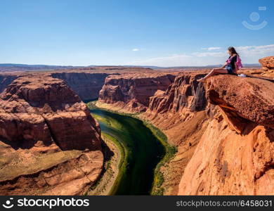 Tourist at Horseshoe Bend on Colorado River in Glen Canyon, Arizona, USA