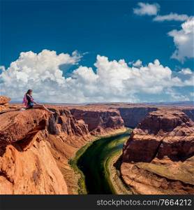 Tourist at Horseshoe Bend on Colorado River in Glen Canyon, Arizona, USA