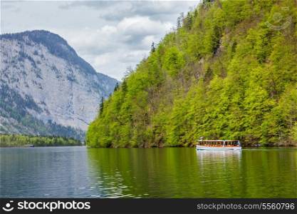 Tourist boat at alpine mountain lake Konigssee, Bavaria, Germany