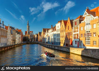 Tourist boat on canal Spiegelrei and Jan Van Eyck Square in the morning in Bruges, Belgium