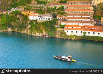 Tourist boat on Douro river in Porto, Portugal. Aerial view.