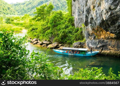 Tourist boats, the mouth of Phong Nha cave with underground river, Phong Nha-Ke Bang National Park, Vietnam