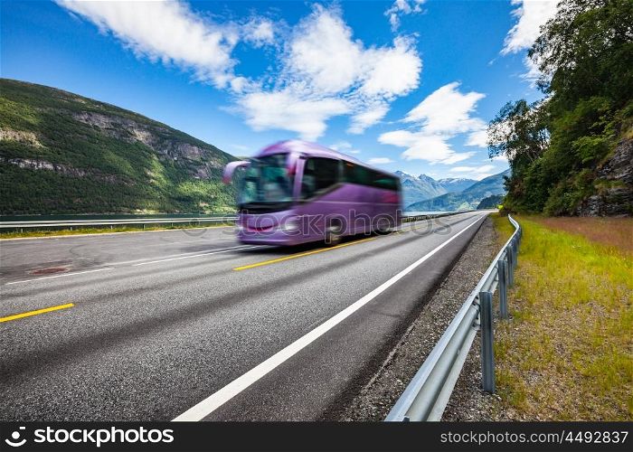 Tourist bus traveling on the road in Norway. Tourist bus in motion blur.