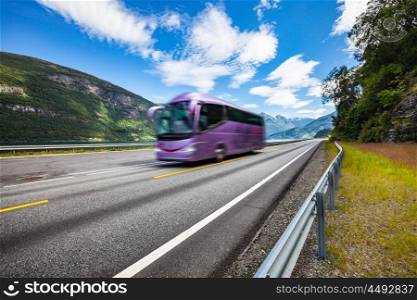Tourist bus traveling on the road in Norway. Tourist bus in motion blur.