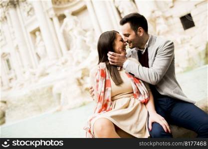 Tourist couple on travel by Trevi Fountain in Rome, Italy.