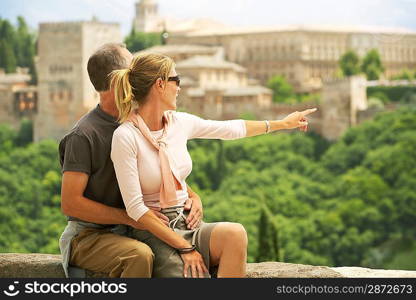 Tourist Couple Relaxing on Wall