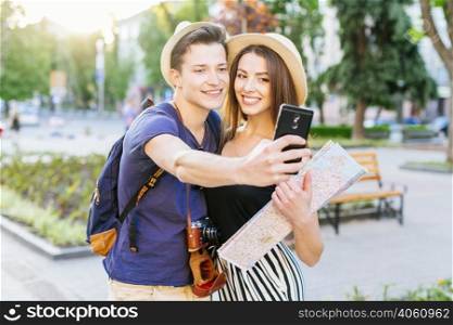 tourist couple taking selfie park