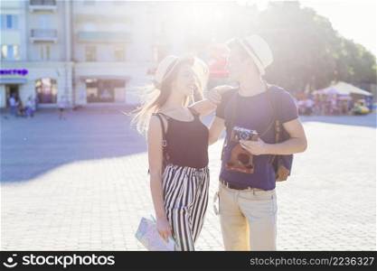 tourist couple visiting city with sun effect