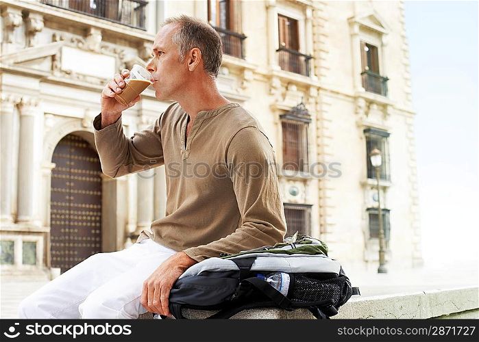 Tourist Drinking Latte in Square