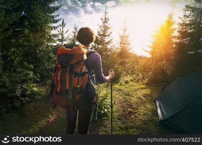 tourist girl stands near the tent in the mountain. Carpathians, Ukraine.