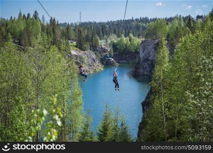Tourist gliding on the zipline trip in Marble quarry of Ruskeala Park