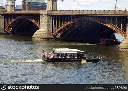Tourist in a streamer near an arch bridge, Boston, Massachusetts, USA
