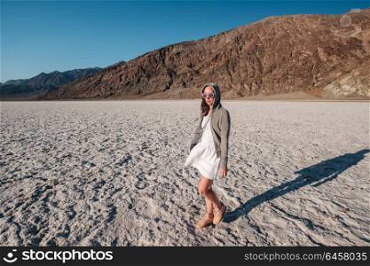 Tourist in Badwater Basin at hot summer day, Death Valley National Park, California, USA.