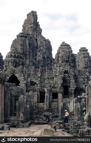 Tourist in Bayon temple, Angkor, Cambodia