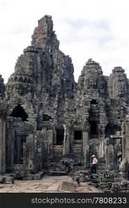 Tourist in Bayon temple, Angkor, Cambodia