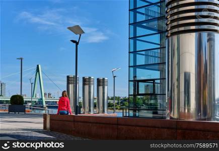 Tourist in Cologne near Kranhaus building complex with crane house on riverside of Rhein in Cologne, Germany.