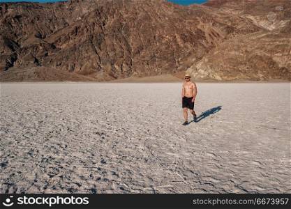 Tourist in Death Valley National Park. Tourist in Badwater Basin at hot summer day, Death Valley National Park, California, USA.