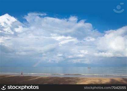 Tourist is taking photos of the rainbow on the beach in the morning at Ko Koh khao island, Phang Nga, Thailand