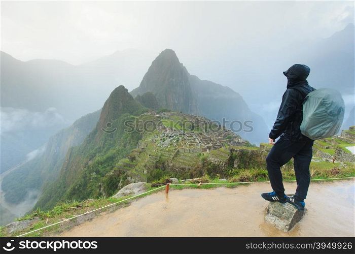 Tourist looking over Machu Picchu, Peru