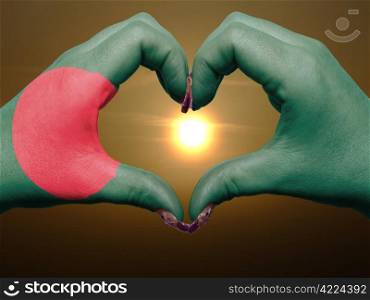 Tourist made gesture by bangladesh flag colored hands showing symbol of heart and love during sunrise