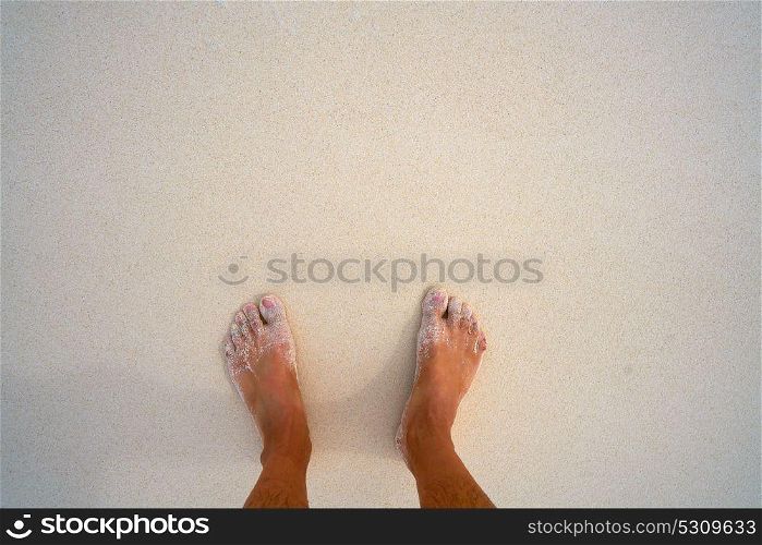 Tourist man feet in tropical white sand beach vacation concept