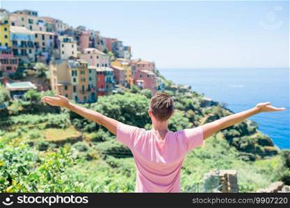 Tourist man looking at scenic view of Manarola, Cinque Terre, Liguria, Italy. Tourist looking at scenic view of Manarola, Cinque Terre, Liguria, Italy