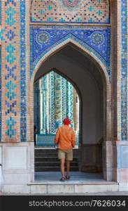 Tourist near ancient historic building in Uzbekistan